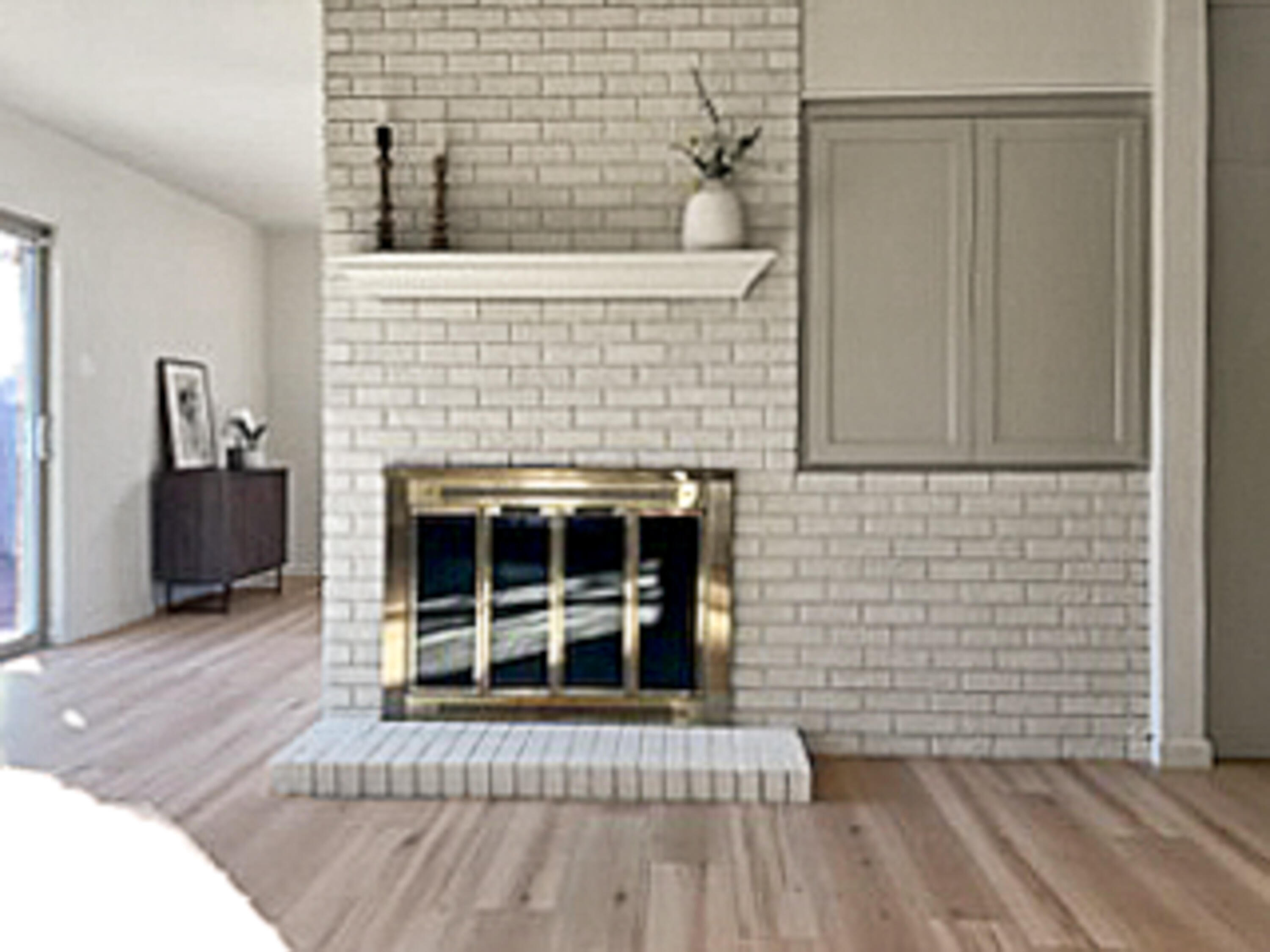3625 59th Street Lubbock, TX 79413 - Photo 6 of 41 a view of empty room with wooden floor and fireplace