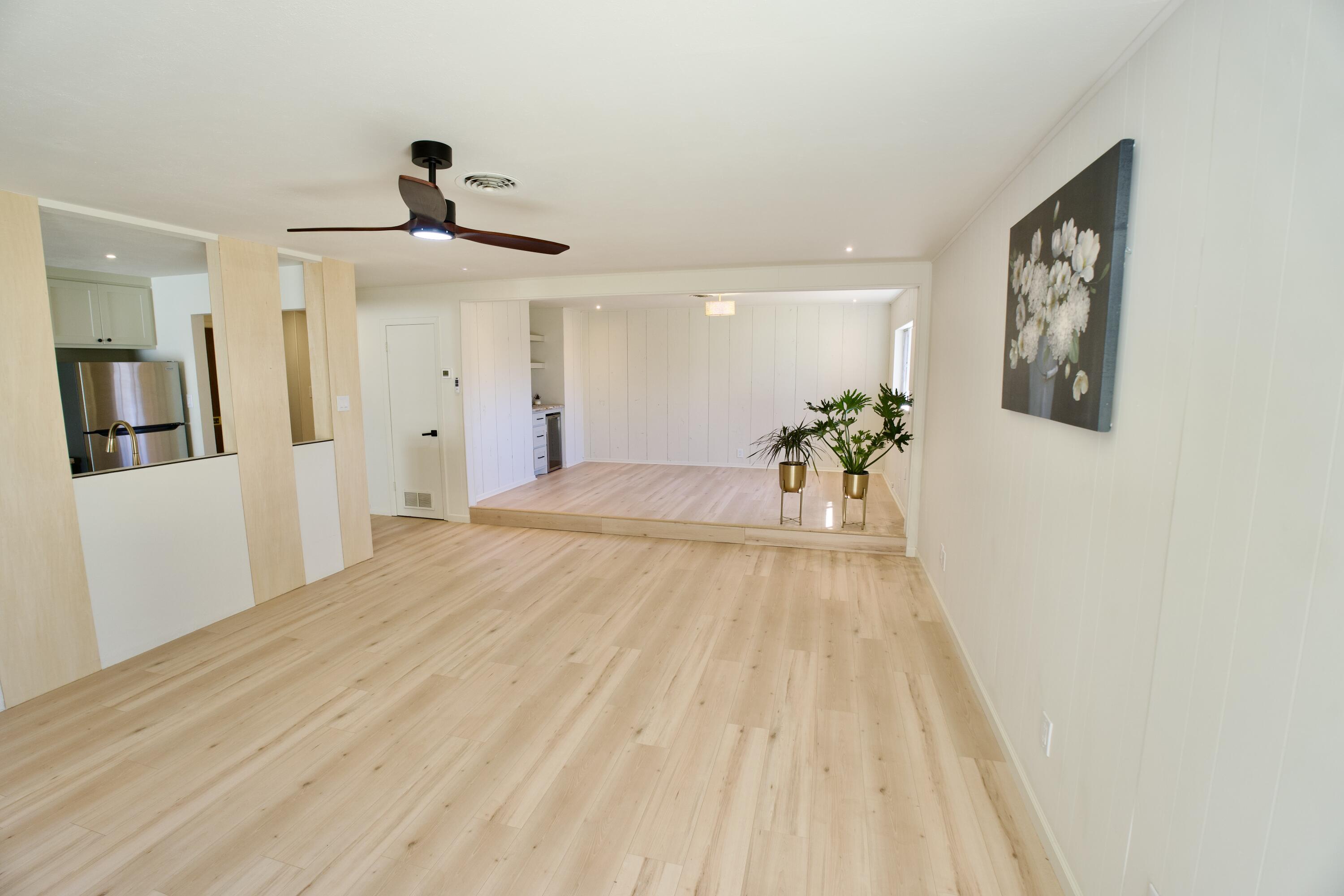 3625 59th Street Lubbock, TX 79413 - Photo 10 of 41 a view of a room with wooden floor and ceiling fan