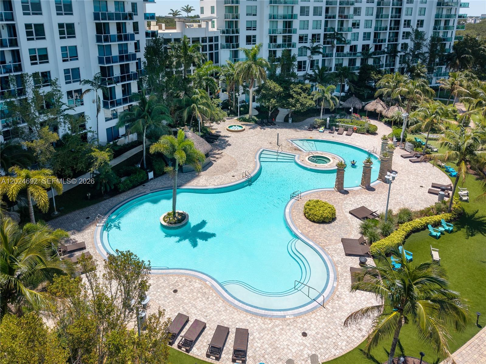 2641 North Flamingo Road, Unit 2605N Sunrise, FL 33323 - Photo 45 of 56 a view of a swimming pool with a garden