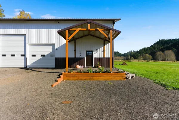 a front view of house with yard and car parked