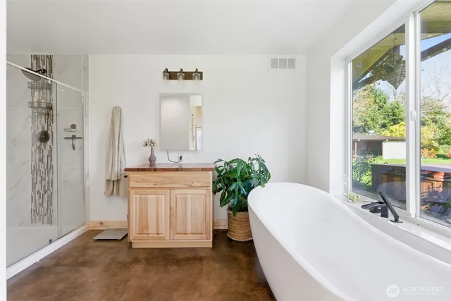 a spacious bathroom with a granite countertop tub sink and mirror