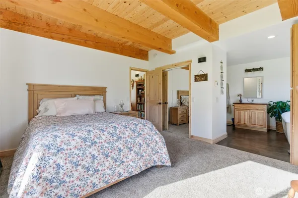 a bedroom with a large bed and closet