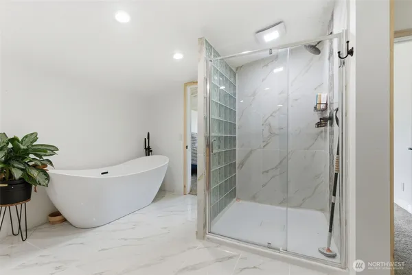 a bathroom with a bathtub and a shower