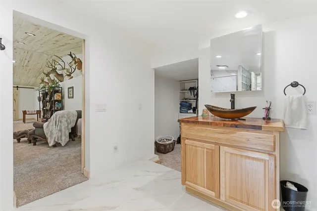 a bed room with a bed and a view of living room