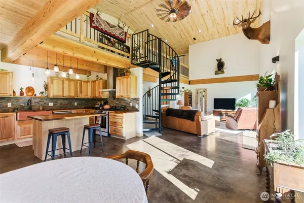 a living room with furniture a fireplace and a chandelier