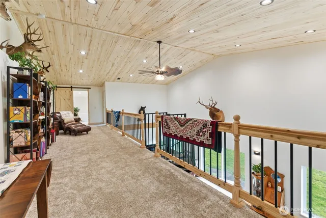 a bed sitting in a spacious bedroom next to a window