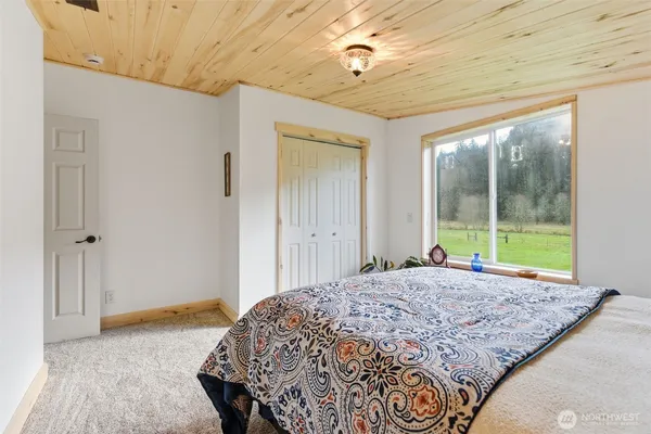 a bed room with a bed and a chair