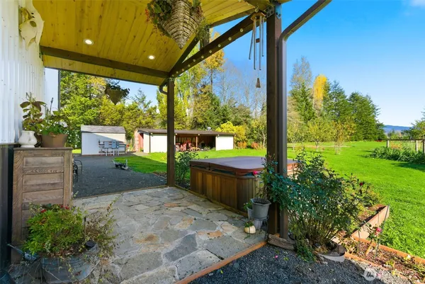 a view of a house with backyard and sitting area