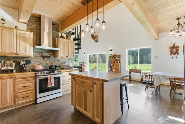 a kitchen with stainless steel appliances granite countertop a stove and cabinets