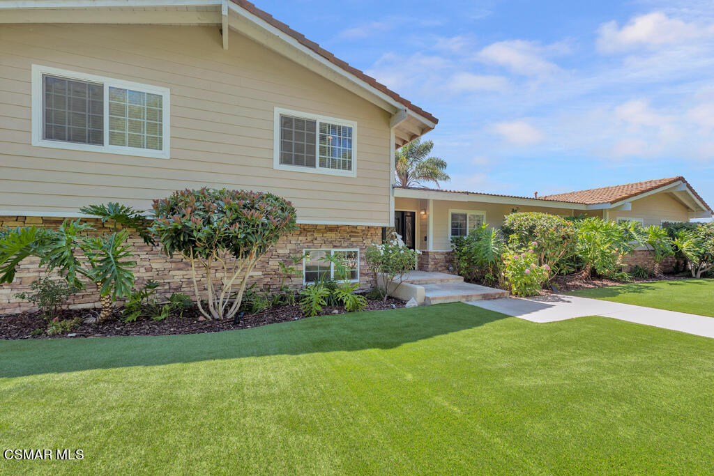 a front view of house and yard with green space