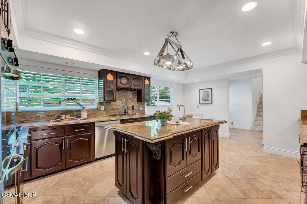 1631 Hauser Circle Thousand Oaks, CA 91362 - Photo 15 of 56 a kitchen with stainless steel appliances granite countertop a sink and a stove