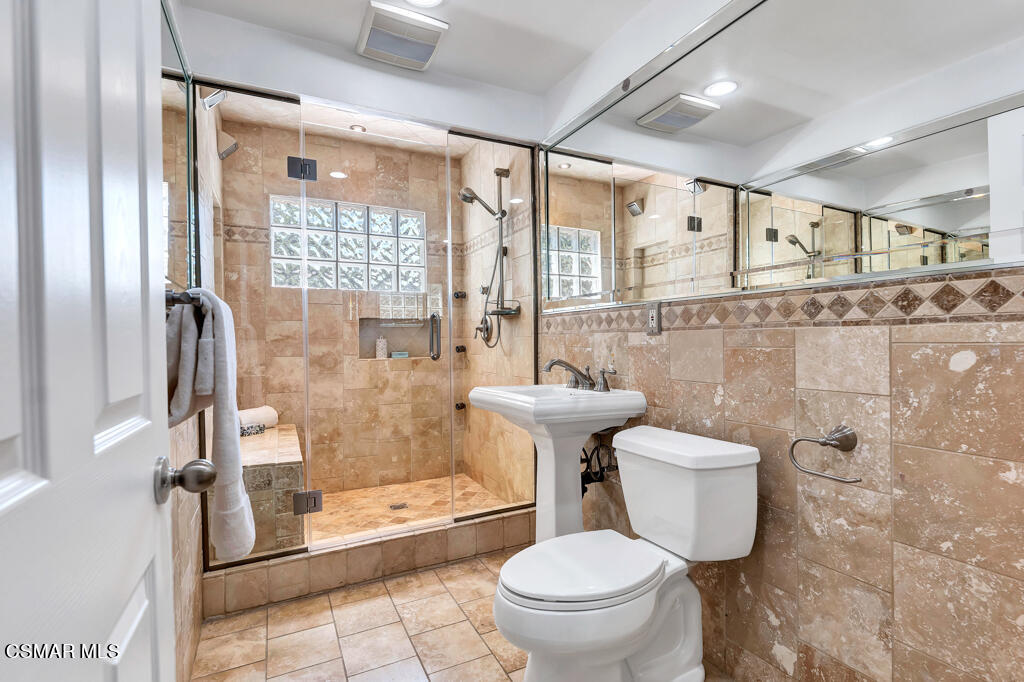 1631 Hauser Circle Thousand Oaks, CA 91362 - Photo 26 of 56 a bathroom with a granite countertop toilet a sink and a shower