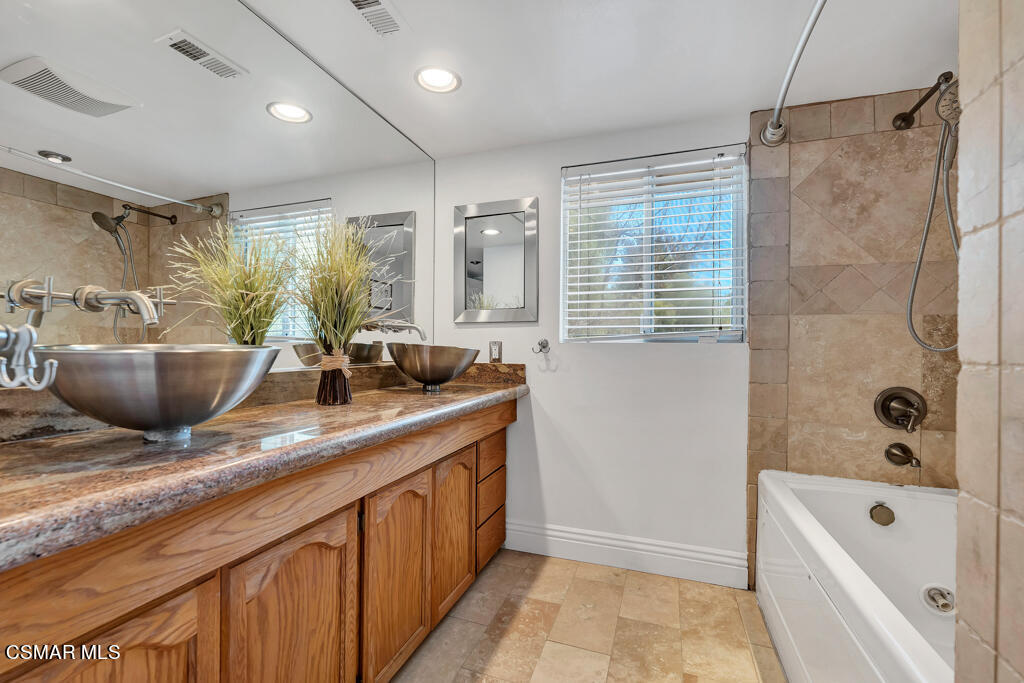 1631 Hauser Circle Thousand Oaks, CA 91362 - Photo 35 of 56 a bathroom with a granite countertop sink a bathtub and shower