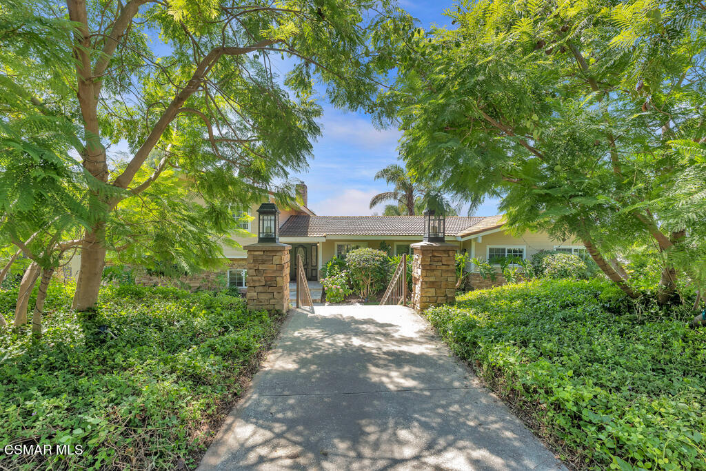 1631 Hauser Circle Thousand Oaks, CA 91362 - Photo 52 of 56 a front view of a house with a yard and potted plants