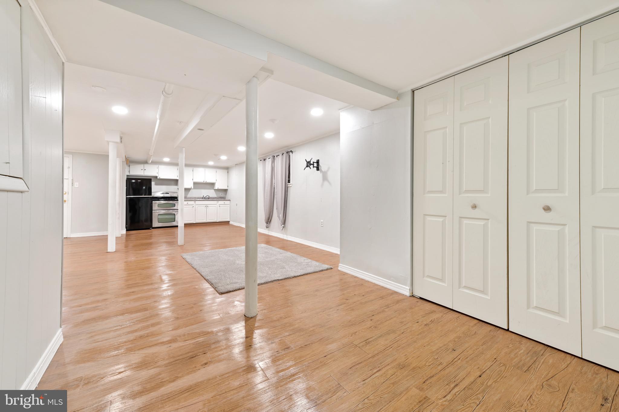 101 East 33rd Street, Unit B Baltimore, MD 21218 - Photo 3 of 7 a view of a hallway with wooden floor and a kitchen