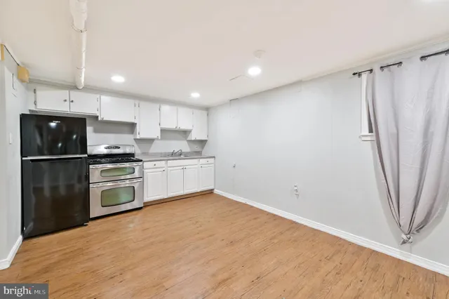 a kitchen with stainless steel appliances a refrigerator sink and microwave