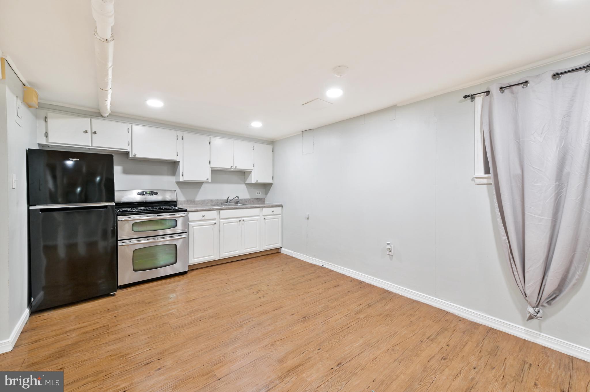 101 East 33rd Street, Unit B Baltimore, MD 21218 - Photo 4 of 7 a kitchen with stainless steel appliances a refrigerator sink and microwave
