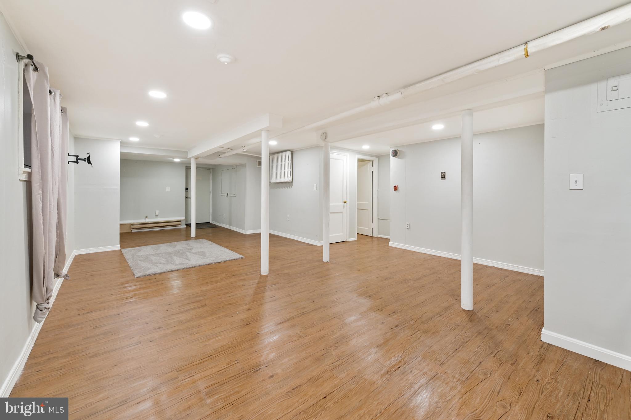 101 East 33rd Street, Unit B Baltimore, MD 21218 - Photo 6 of 7 a view of empty room with wooden floor