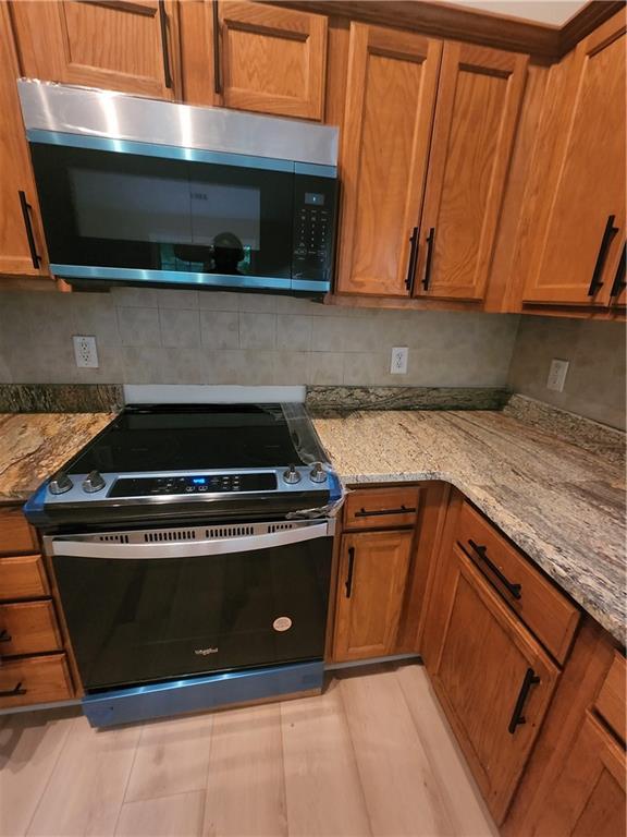 435 Butler Bridge Circle Covington, GA 30016 - Photo 14 of 25 a stove top oven sitting inside of a kitchen