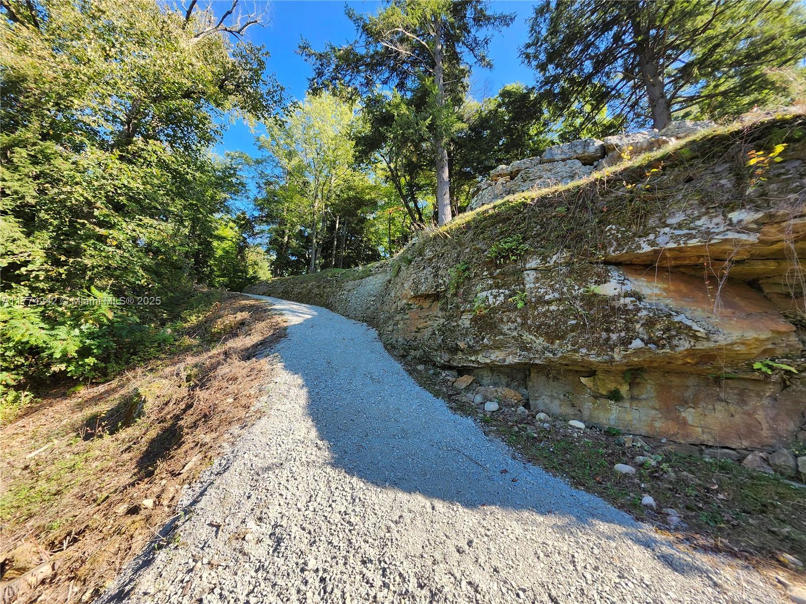 18443 Otter Point Road Wellesley Island, NY 13640 - Photo 12 of 26 The exposed rock gives you a history of time.