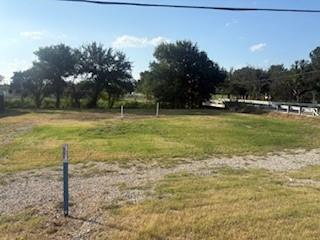 207 Northeast Front Street Millsap, TX 76066 - Photo 6 of 8 a view of a field with trees in the background