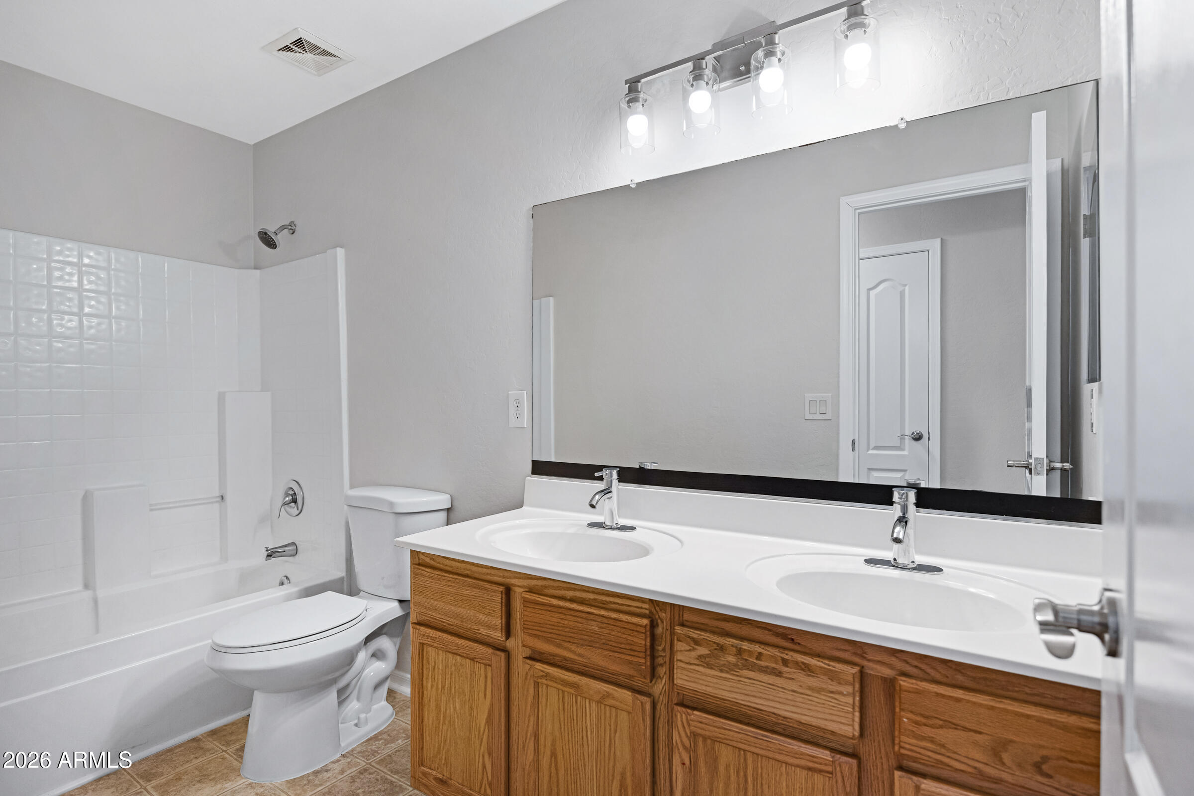 19408 North Braden Road Maricopa, AZ 85138 - Photo 47 of 51 a bathroom with a toilet a sink a mirror and bathtub