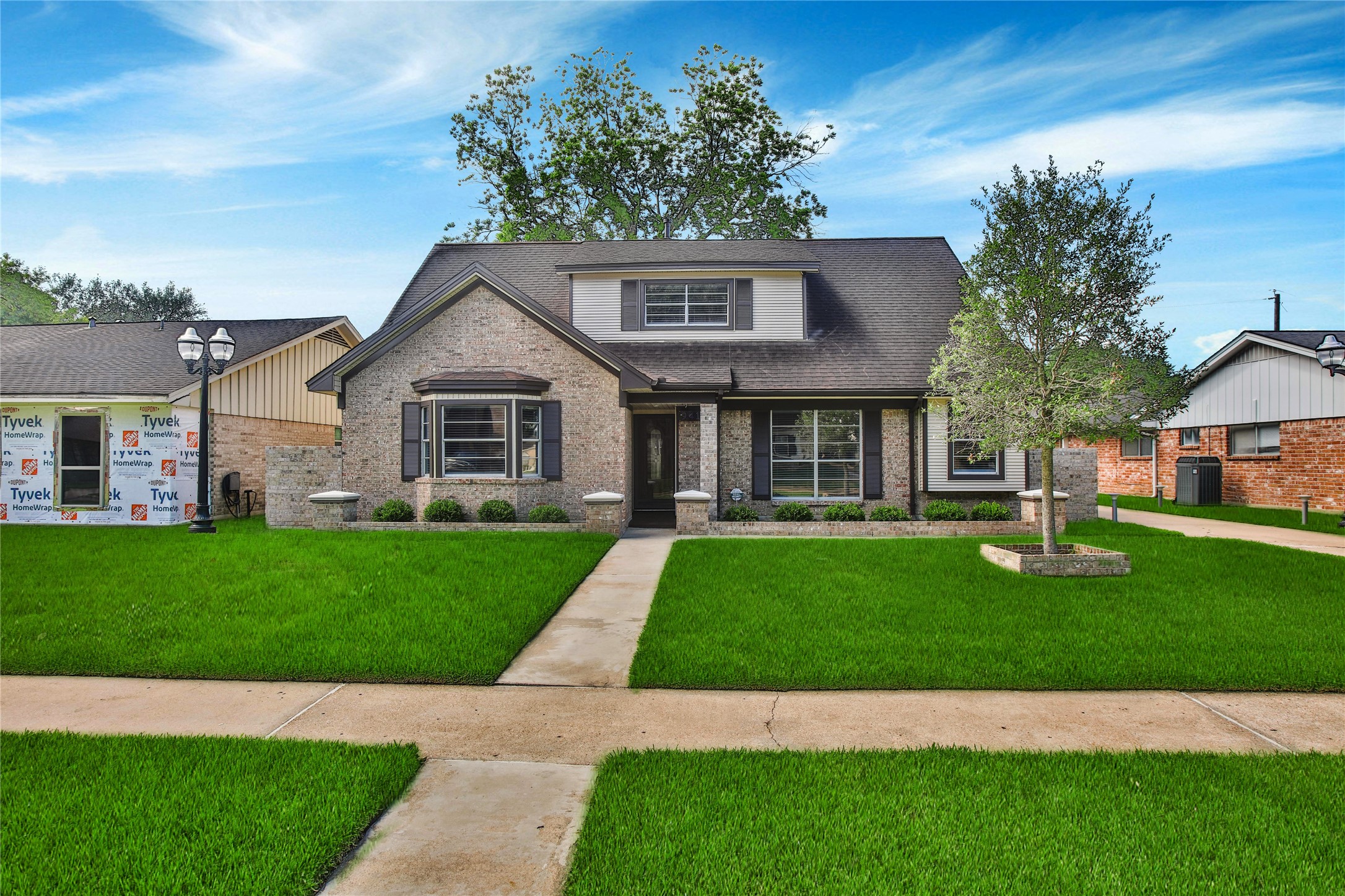 9411 Roos Road Houston, TX 77036 - Photo 2 of 41 a front view of a house with a garden