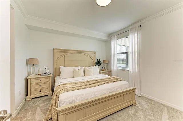 a bedroom with a bed and a potted plant