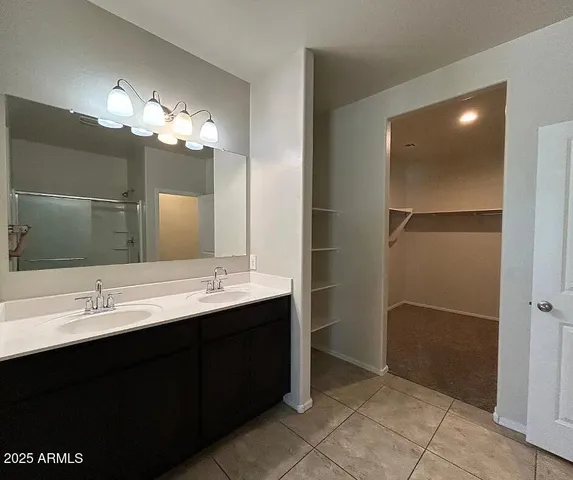 a bathroom with a double vanity sink and a mirror