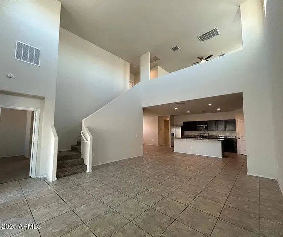 a view of a hallway with entryway and kitchen
