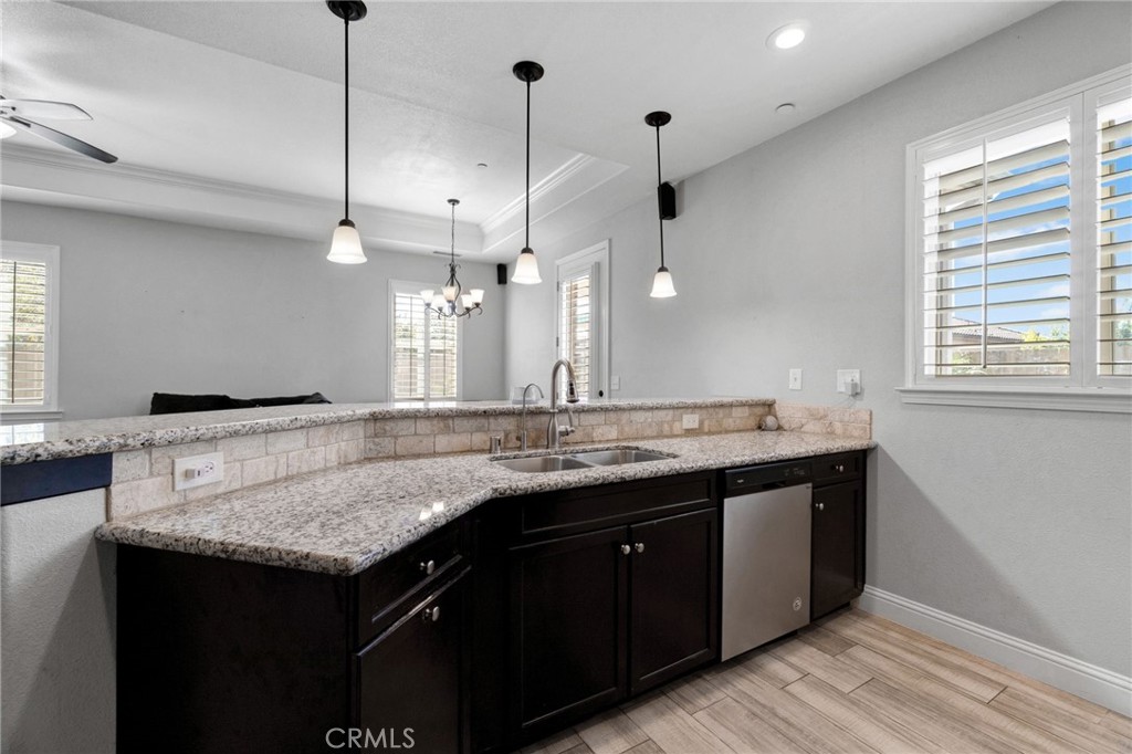294 Double Tree Court Madera, CA 93637 - Photo 15 of 40 a bathroom with a granite countertop sink a toilet a large mirror and vanity