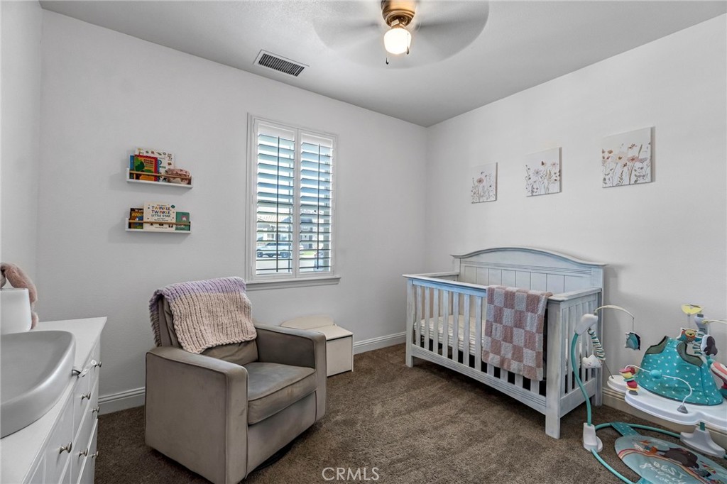 294 Double Tree Court Madera, CA 93637 - Photo 18 of 40 a bedroom with a bed and a couch