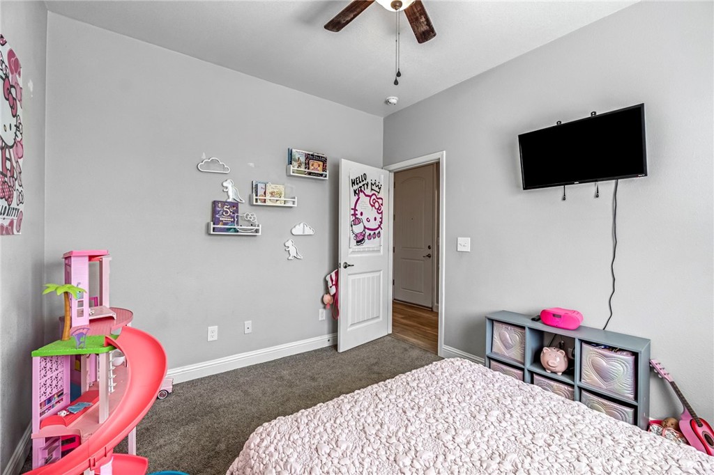 294 Double Tree Court Madera, CA 93637 - Photo 21 of 40 a bedroom with a bed and flat screen tv