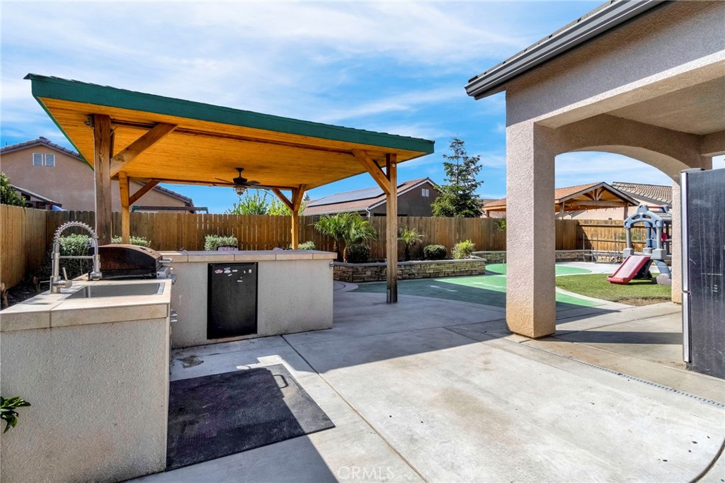 294 Double Tree Court Madera, CA 93637 - Photo 28 of 40 a view of a patio with a table and chairs