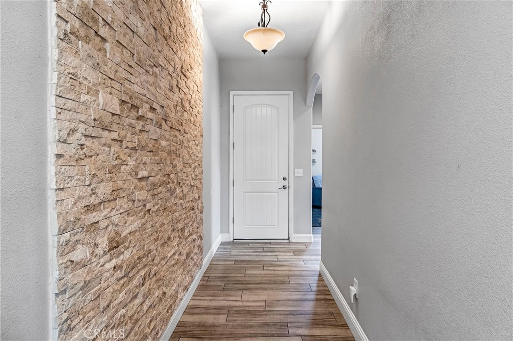 294 Double Tree Court Madera, CA 93637 - Photo 5 of 40 a view of a hallway with wooden floor and a bathroom