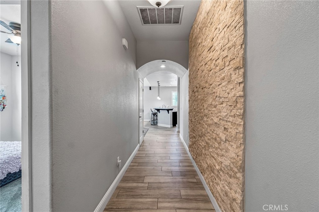 294 Double Tree Court Madera, CA 93637 - Photo 6 of 40 a view of a hallway with wooden floor and a bathroom