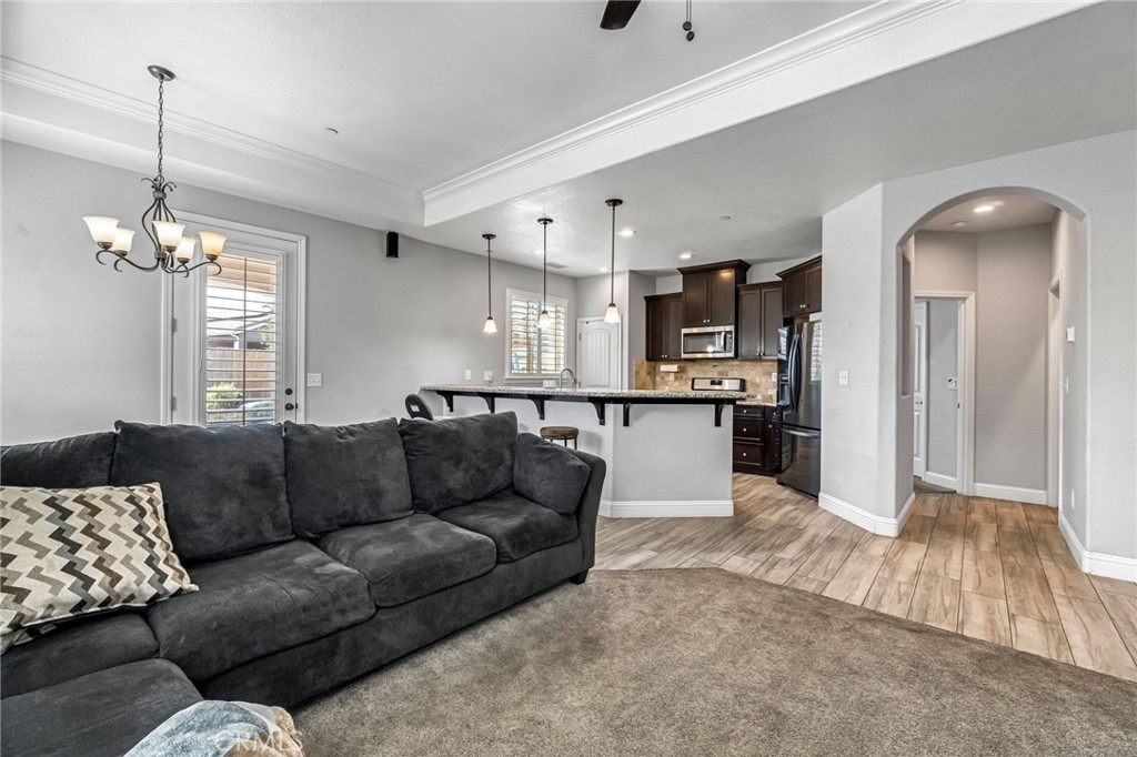 294 Double Tree Court Madera, CA 93637 - Photo 9 of 40 a living room with furniture and kitchen view