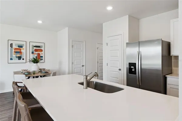 a kitchen with stainless steel appliances kitchen island a refrigerator sink and stove