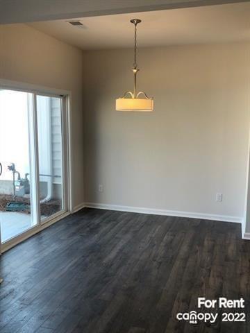 8151 Sheffield Dr. Terrell, NC 28682 - Photo 3 of 15 an empty room with wooden floor and windows