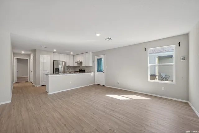 a view of kitchen with wooden floor and windows