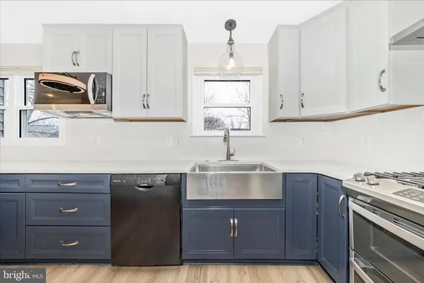 a kitchen with stainless steel appliances granite countertop a stove and a microwave