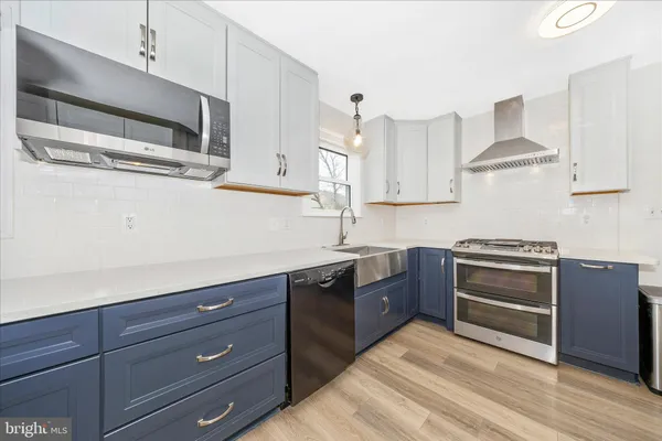 a kitchen with stainless steel appliances a refrigerator sink and stove