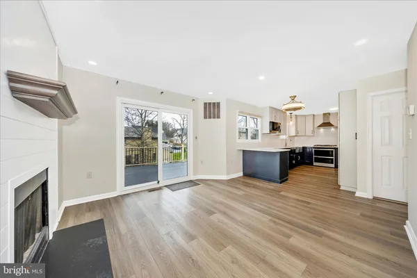 an empty room with wooden floor and ceiling fan