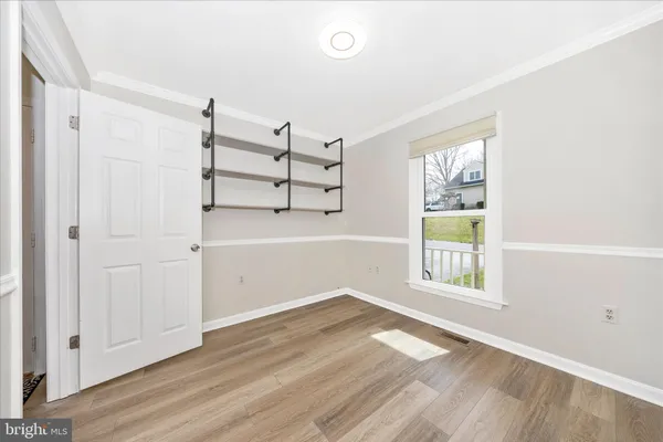 an empty room with windows and closet