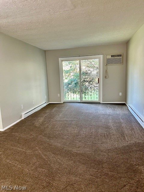 4376 Darrow Road, Unit 7 Stow, OH 44224 - Photo 8 of 23 Carpeted spare room featuring an AC wall unit, a textured ceiling, and baseboard heating
