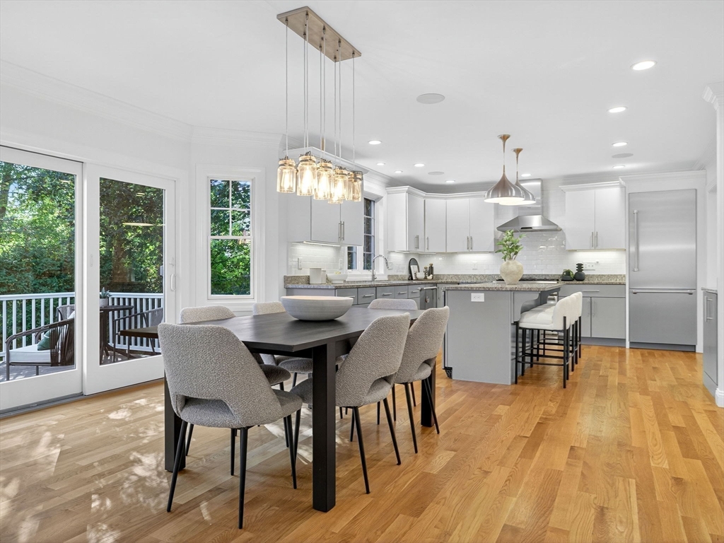79 Peter Parley Road Boston, MA 02130 - Photo 11 of 38 a dining room with stainless steel appliances kitchen island granite countertop a table chairs and a living room view