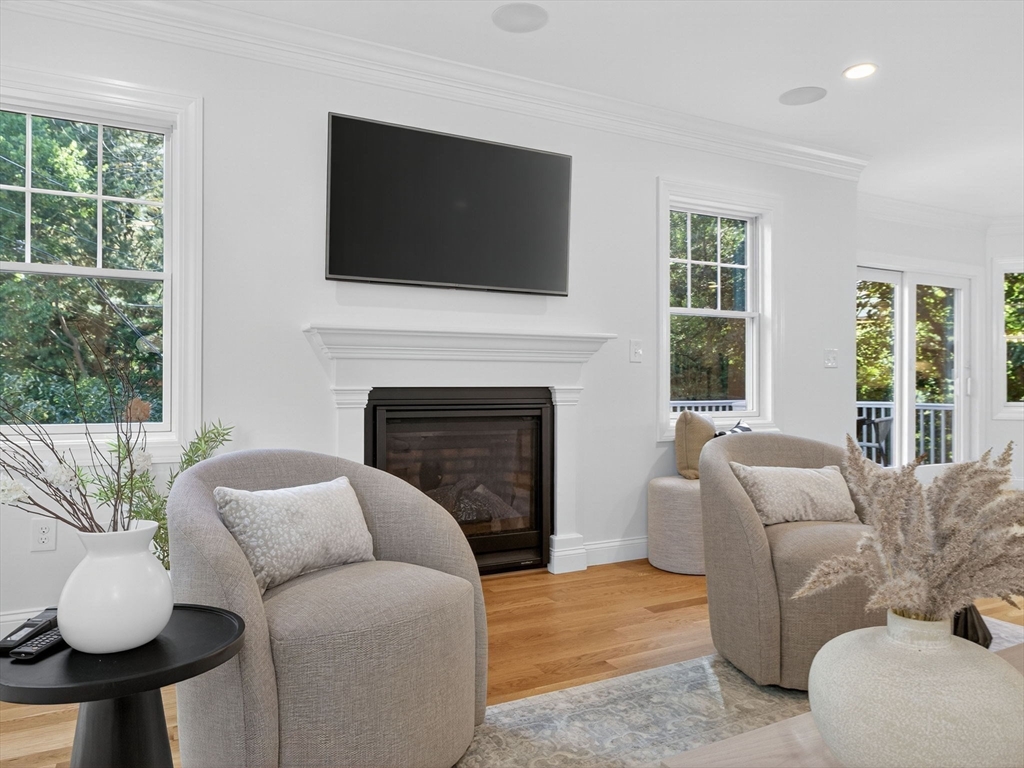 79 Peter Parley Road Boston, MA 02130 - Photo 17 of 38 a living room with furniture a fireplace and a flat screen tv