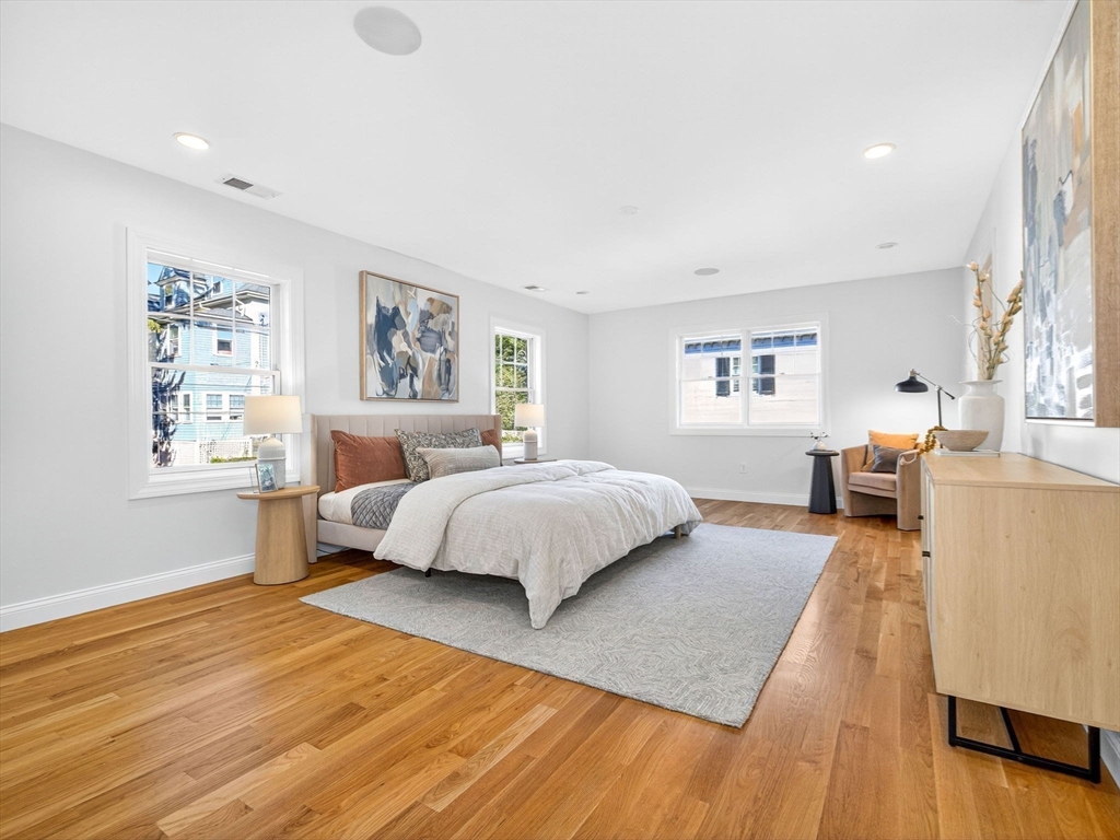 79 Peter Parley Road Boston, MA 02130 - Photo 18 of 38 a spacious bedroom with a large bed and a wooden floor