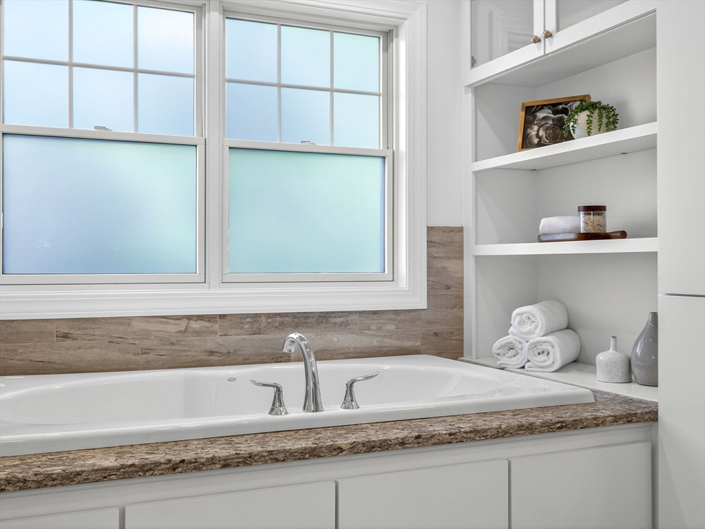 79 Peter Parley Road Boston, MA 02130 - Photo 23 of 38 a bathroom with a granite countertop sink and a mirror