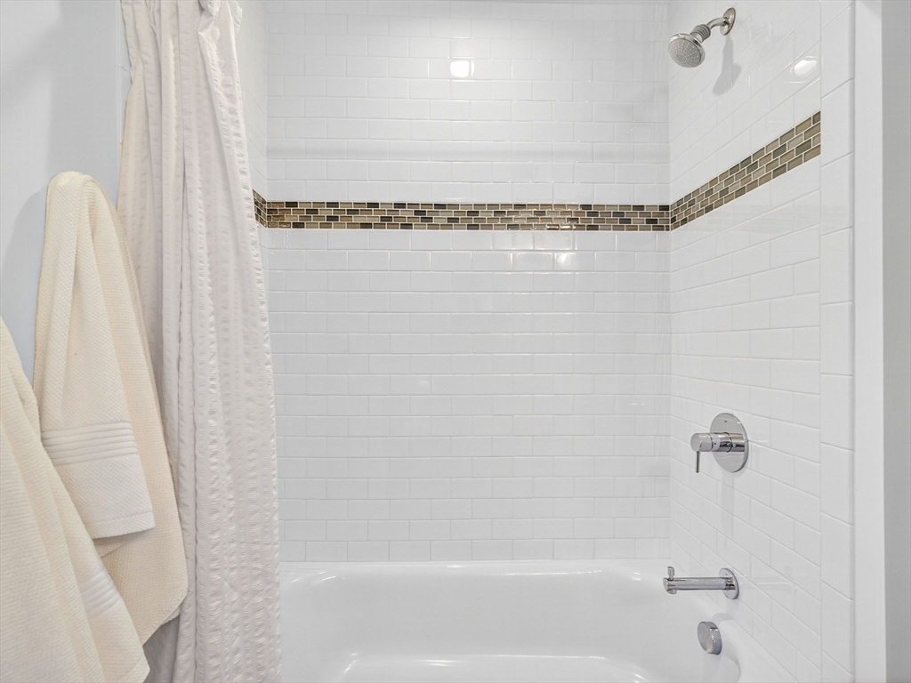 79 Peter Parley Road Boston, MA 02130 - Photo 29 of 38 a bathroom with a shower curtain